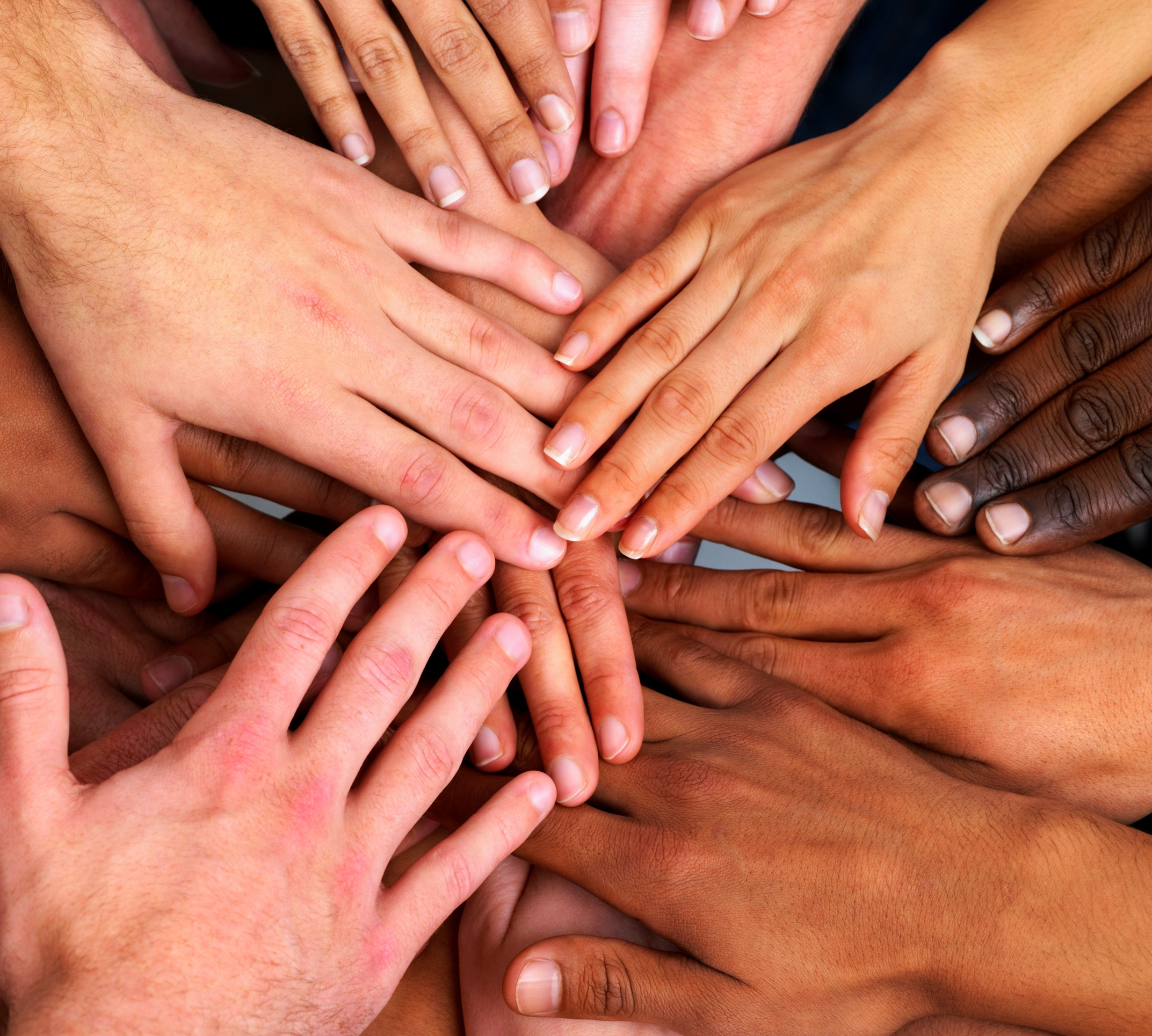 Picture of several hands of joining in a center.
